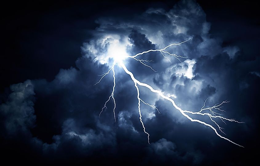 A lightning bolt discharging from storm clouds toward the ground.