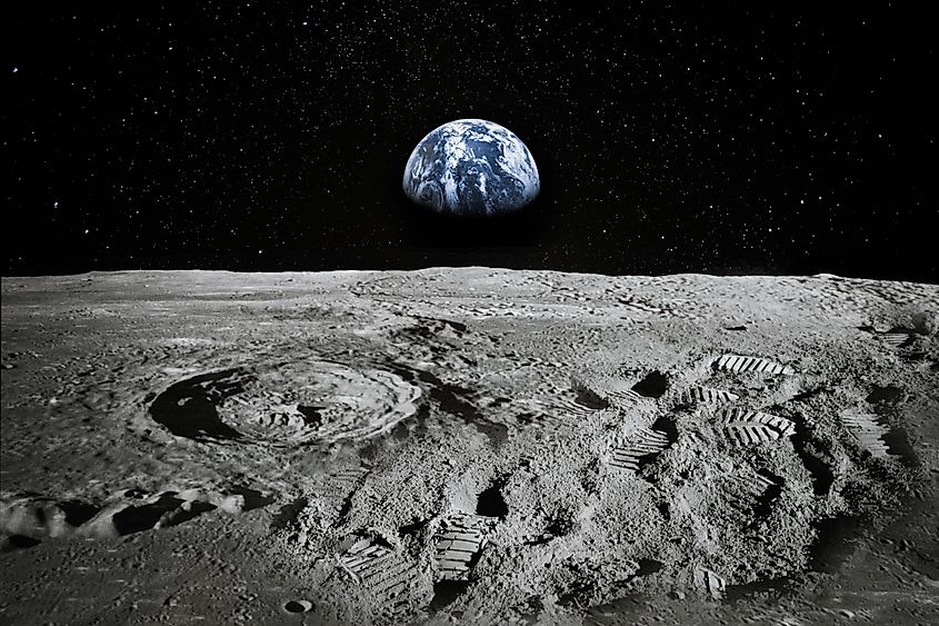 View of Moon limb with Earth rising on the horizon. Footprints as an evidence of people being there or great forgery. Via Shutterstock / elena11
