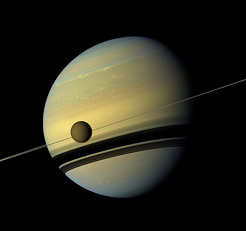 Titan in front of the ring and Saturn (Produced By: Cassini Imaging Team, Image Credit: NASA/JPL-Caltech/Space Science Institute, Public domain, via Wikimedia Commons)