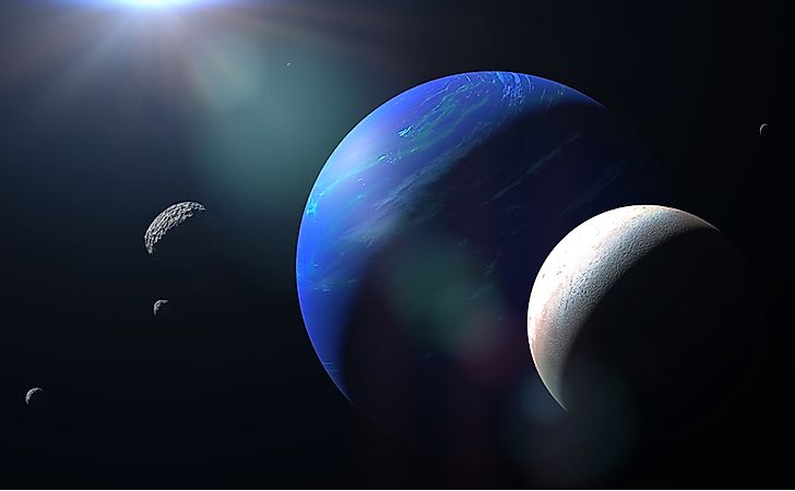 Planet Neptune with its moon Triton and other moons. Via Shutterstock / dotted yeti