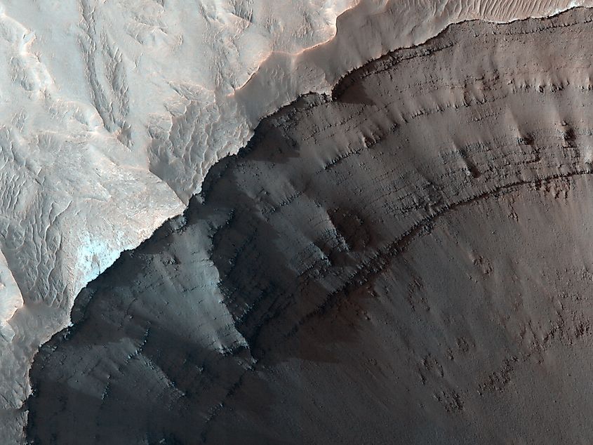 Rim of Ganges chasma, closeup showing stratigraphy and small landslides.