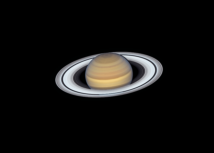 Saturn and its rings photographed against black space by the Hubble Space Telescope