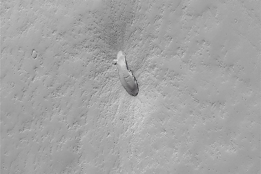 A small dust-covered shield volcano on the Martian plains east of Pavonis Mons