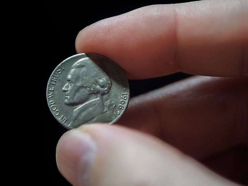 Close-Up of a Hand Holding a Nickel. 