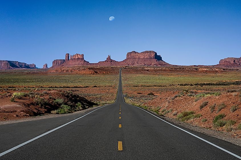 Monument Valley at Mile Marker 13 with a moon rising. Credit: Donald Hacker / Shutterstock