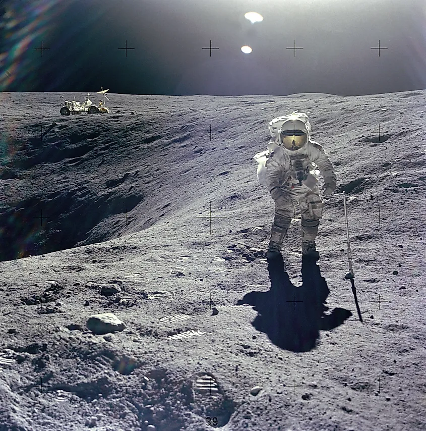Astronaut Charles Duke working on the Moon with his suit covered in lunar dust.