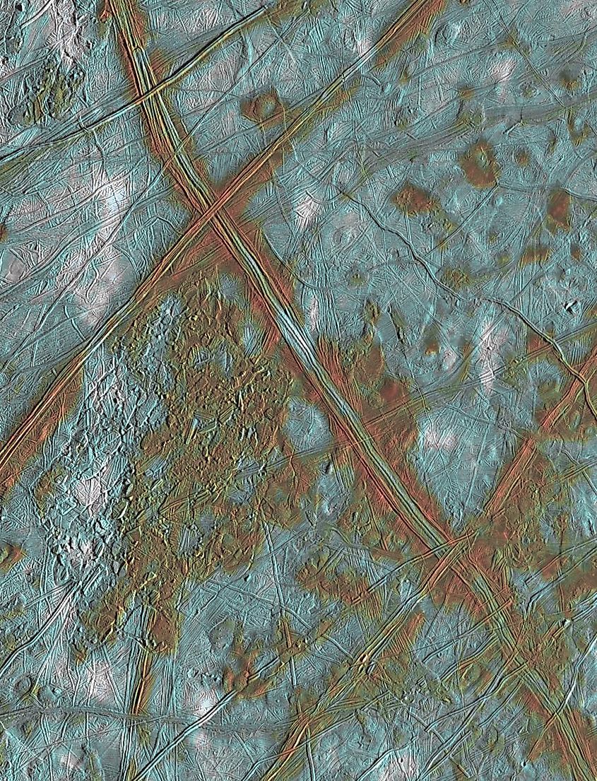 Long reddish-brown cracks crossing the icy surface of Jupiter's moon Europa
