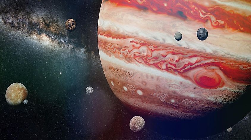 An illustration of Jupiter with several of its moons in orbit around it.