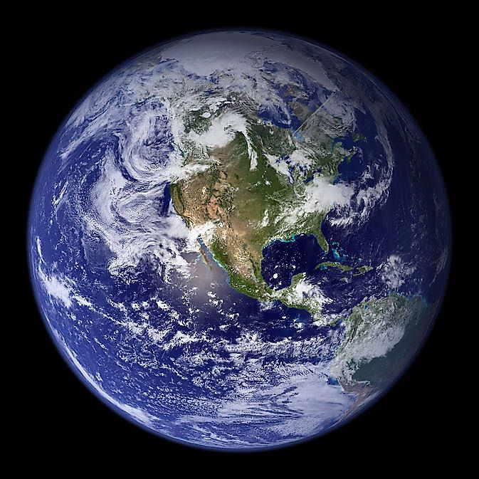 Earth photographed from space, showing cloud cover over the oceans.